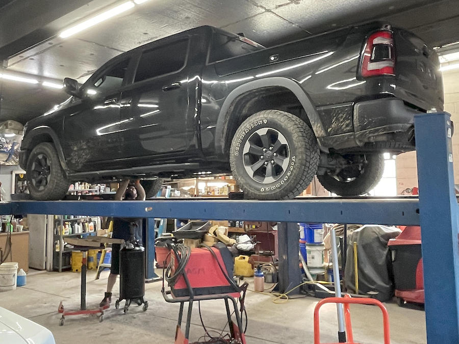 Truck on a lift being worked on from below